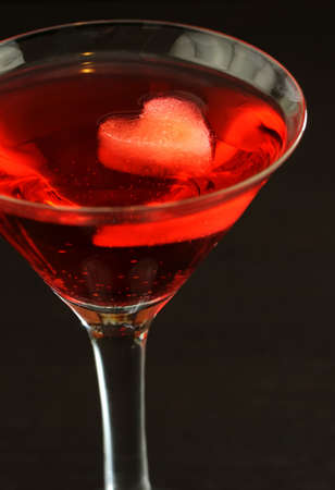 A red martini cocktail with heart shaped ice cubeの写真素材