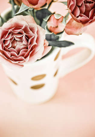 cup full of pink rosesの写真素材