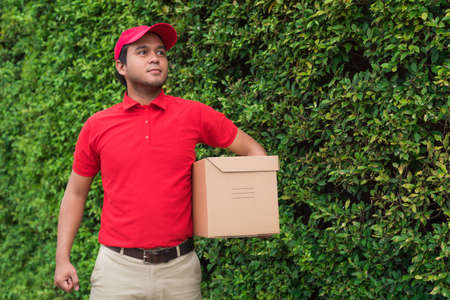 delivery man in red uniformの写真素材
