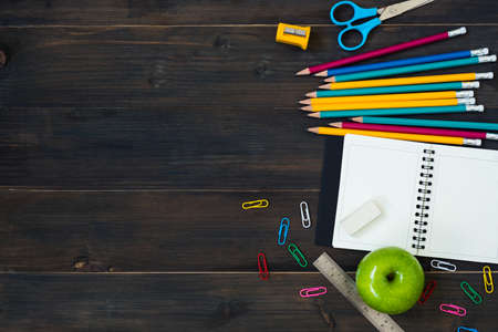 Top view of School Supplies on a wooden table with space for textの写真素材