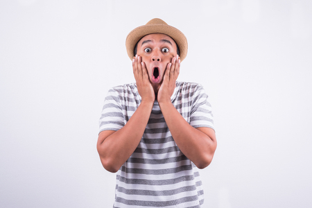 Shocked face of asian young manの写真素材
