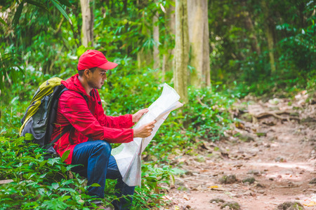Young asian travel handsome man hiking in forest and mountain enjoy walking in nature outdoors. Image of lifestyle camping,travel,hiking or recreation concept with copy space.の写真素材