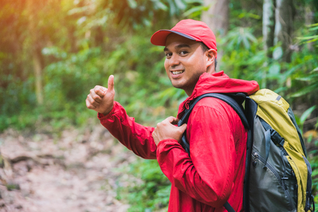 Young asian travel man hiking in forest and mountain enjoy walking in nature outdoors.の写真素材