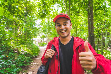 Young asian travel man hiking in forest and mountain enjoy walking in nature outdoors.の写真素材