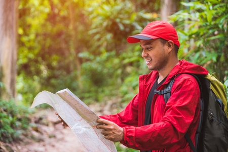 Young asian travel handsome man hiking in forest and mountain enjoy walking in nature outdoors.の写真素材