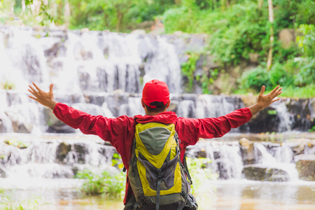 Young asian travel handsome man hiking in forest and mountain enjoy walking in nature outdoors.の写真素材