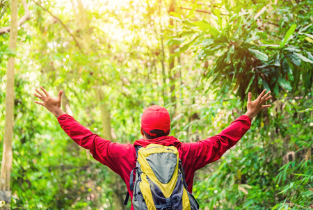 Traveling tourist asian man Backpacker enjoying walking in nature outdoors in forest.の写真素材