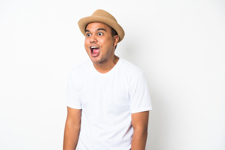 Young asian man with hat feels shock and surprise with overly face expression and looking on blank space.の写真素材