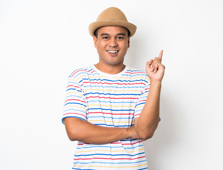 Young happy&funny asian man pointing finger on blank space for text.の写真素材