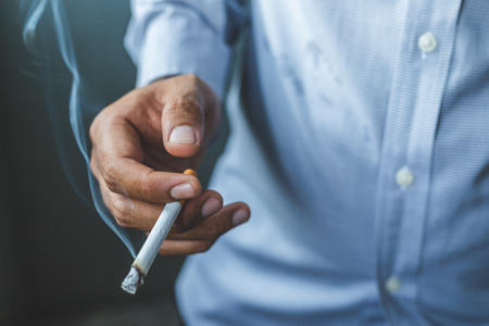 Cigarette in handの写真素材