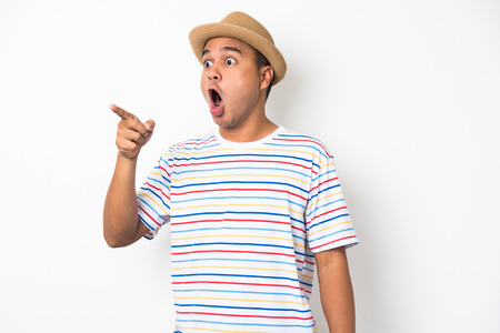 Young happy&funny asian man pointing finger on blank space for text.の写真素材
