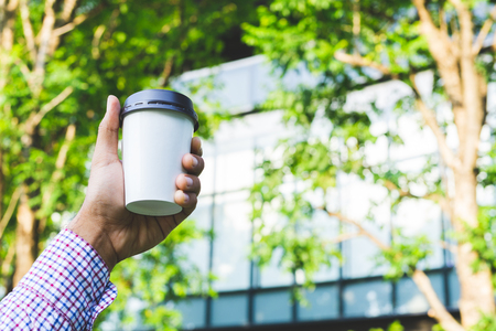 Close up hand man holding coffee paper cup.の写真素材