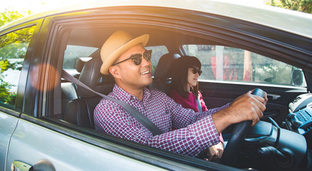Happy moment couple asian man and woman sitting in car. Enjoying travel concept.の写真素材