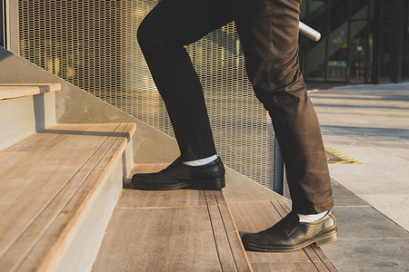 Businessman legs walking up the stairsの写真素材