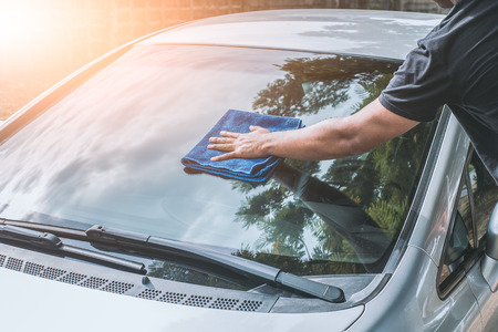 Hand man cleaning car with microfiber clothの写真素材