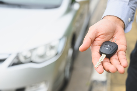 Businessman giving a car key. Getting new car concept.の写真素材
