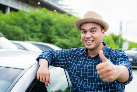 Young man get a new car and thumb up