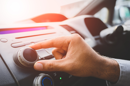 Close up male hand tuning of car radio.の写真素材
