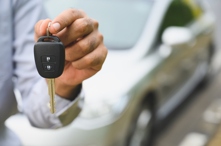 Businessman giving a car key. Getting new car concept.の写真素材