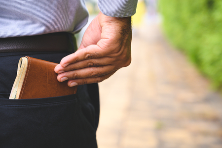 Business man safe keeping money wallet in the back pocket.の写真素材