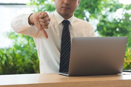 Business man in white shirt showing thumb down.の写真素材