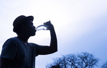 Young asian man drinking water