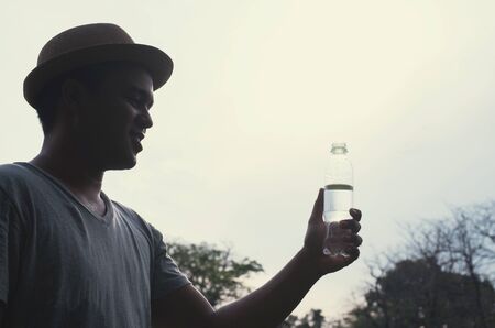 Young asian man drinking waterの写真素材