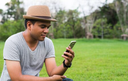 Young asian man using smartphone.