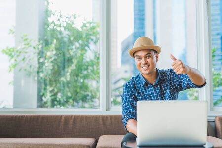 Young asian man working on laptopの写真素材