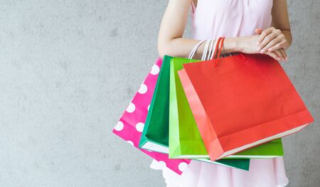 Close up of woman hand holding shopping bags.の写真素材