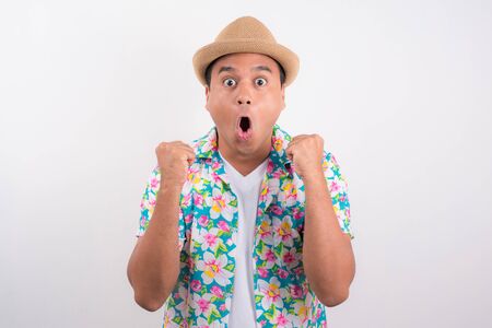 Happy excited asian man. He wearing summer shirt in Songkran festival Thailand concept.の写真素材