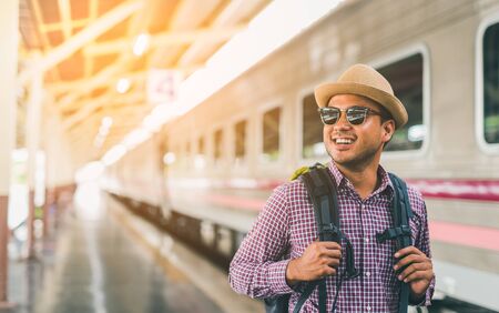Young traveler man at platform train station. Traveling concept.の写真素材