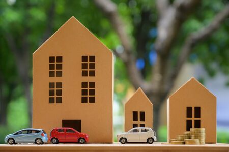 Saving money concept. Buy car, house, stack of coins.の写真素材