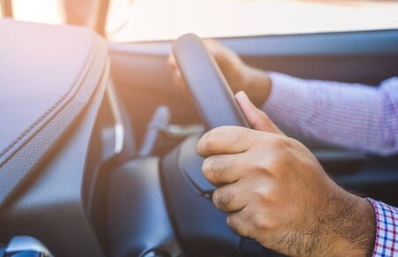Close up front view hands hold steering wheel. Driving car concept.