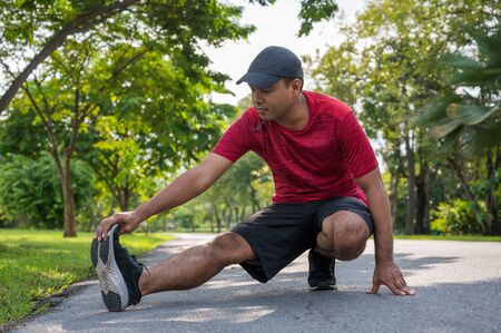 Young fitness man runner stretching before run healthy lifestyle and sport conceptsの写真素材