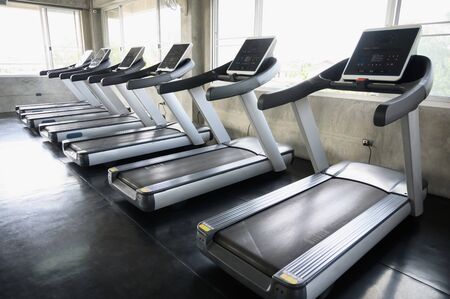 Rows of Treadmills in the gym background for banner presentation. Themes about exercise for good health.の写真素材