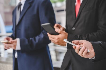 Business groups are using mobile phones to make business contacts, trade, communications, stocks, finance, technology.の写真素材