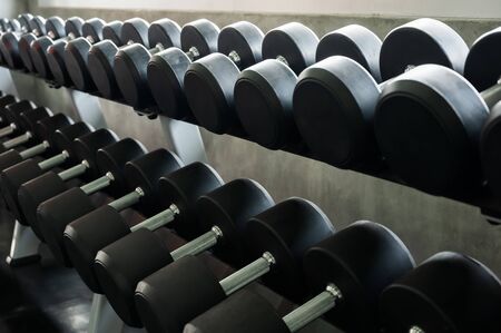 Rows of dumbbells in the gym background for banner presentation. Themes about exercise for good health.の写真素材
