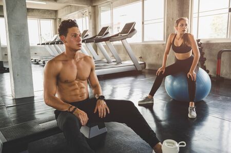 Couple love young fitness man and women workout exercise together. Weight training and cardio...