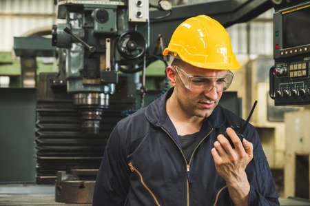 Industrial workers are working on projects in large industrial plants with many devices.の写真素材