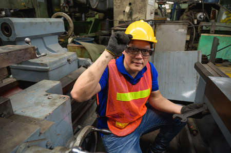 Asian Industrial workers are working on projects in large industrial plants with many devices.