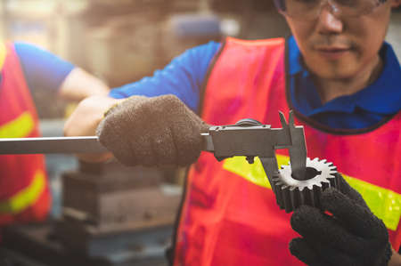 Asian Industrial workers are working on projects in large industrial plants with many devices.