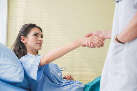 Female doctor meet the patient and handshakeの写真素材