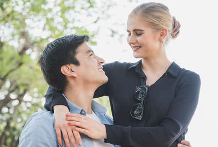 Female hugging male on the back. couple love concept.の写真素材