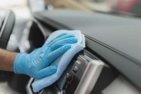 Man cleaning car with microfiber cloth