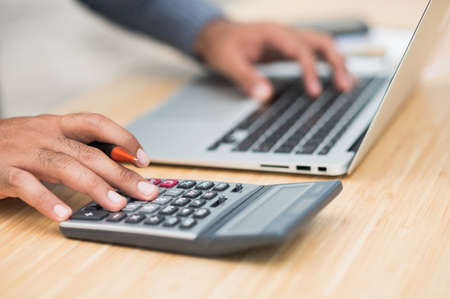 Close up businessman hand using calculator and laptop computer  Financial administration. Buying...