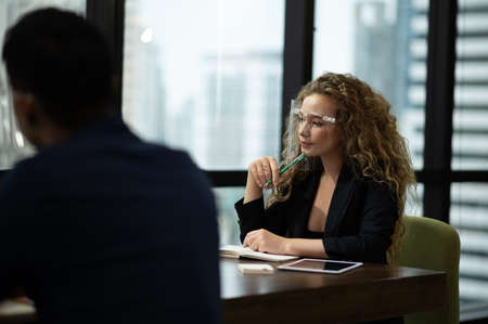 Beautiful business women conference with team in office wearing proptection face mask.の写真素材