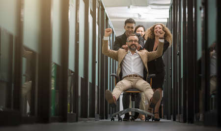 Business team celebrating in office. Successful entrepreneurs and business people achieving goals....