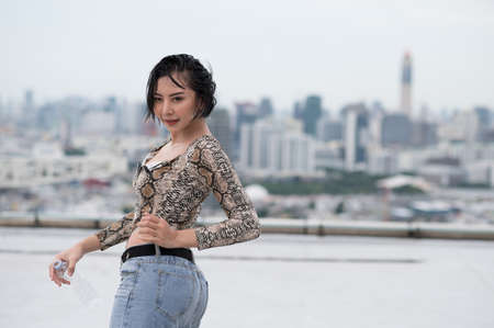 Asian sexy woman dancing on rooftop of the building.の写真素材