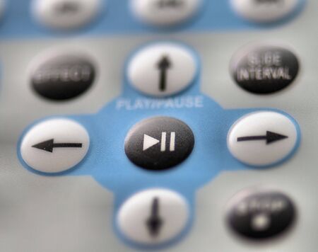 Remote controller with play and pause buttons on focusの写真素材